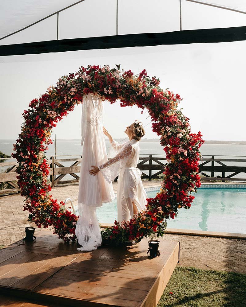 Floral wedding arch beside a pool in Bali