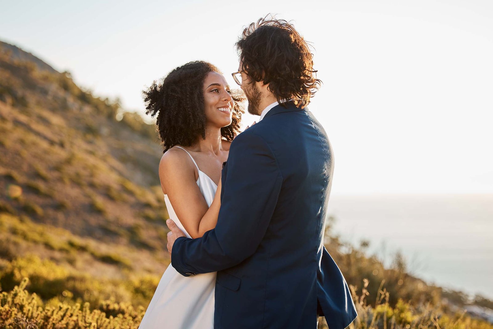 Couple embracing on the cliffs at sunset