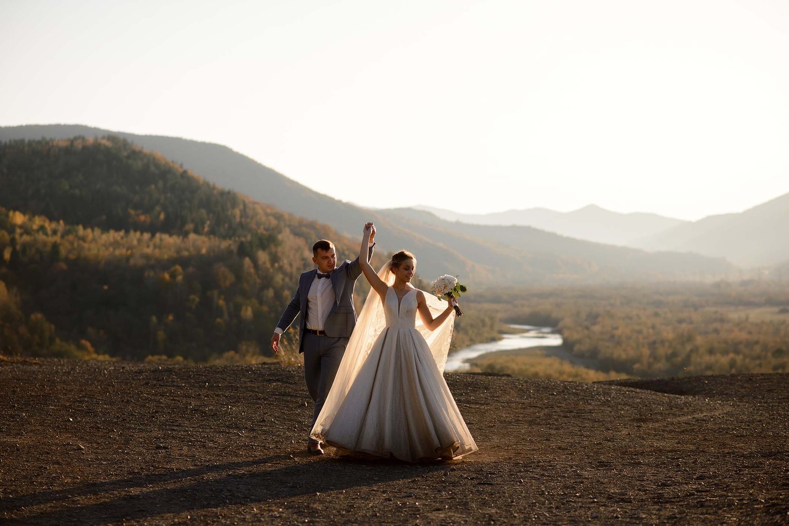 Bride and groom celebrating in the highlands at golden hour